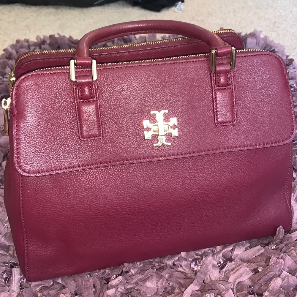 Tory Burch Maroon handbag with cross body strap.